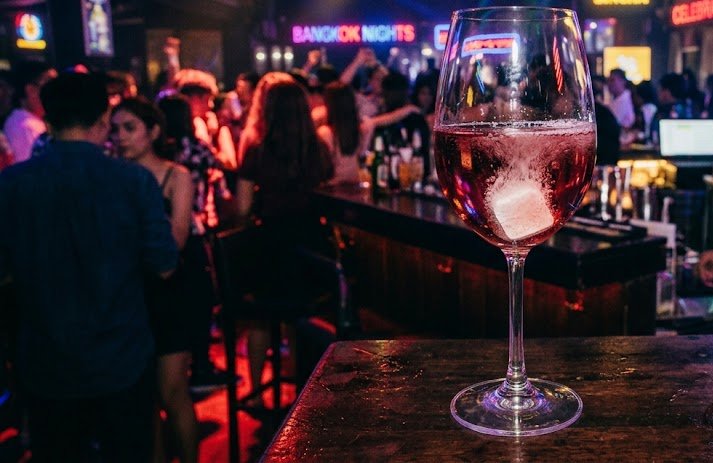Picture of a tablet dissolving in a wineglass at a nightclub