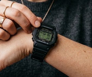 Person adjusting their watch